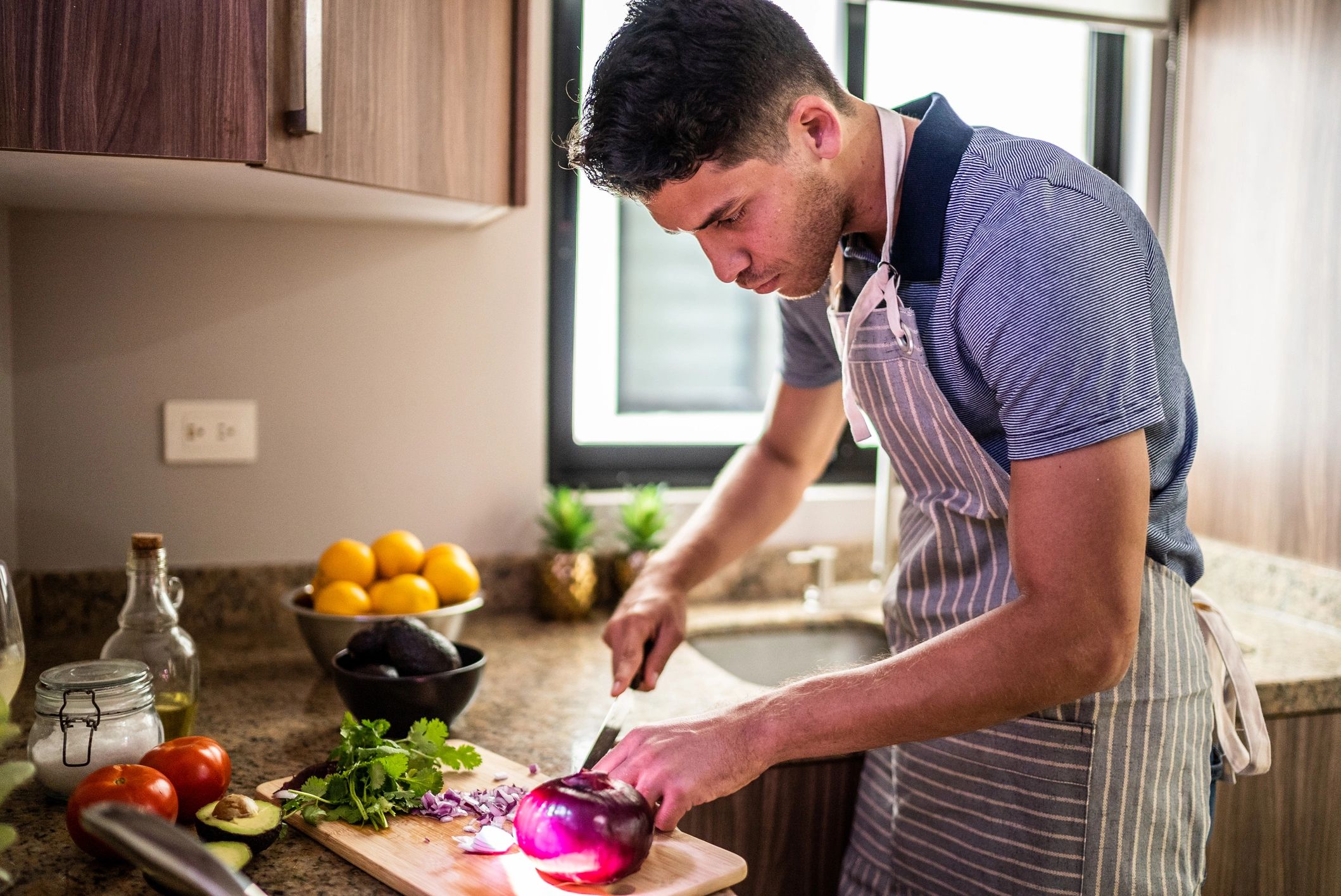 Young man preparing food in a home kitchen