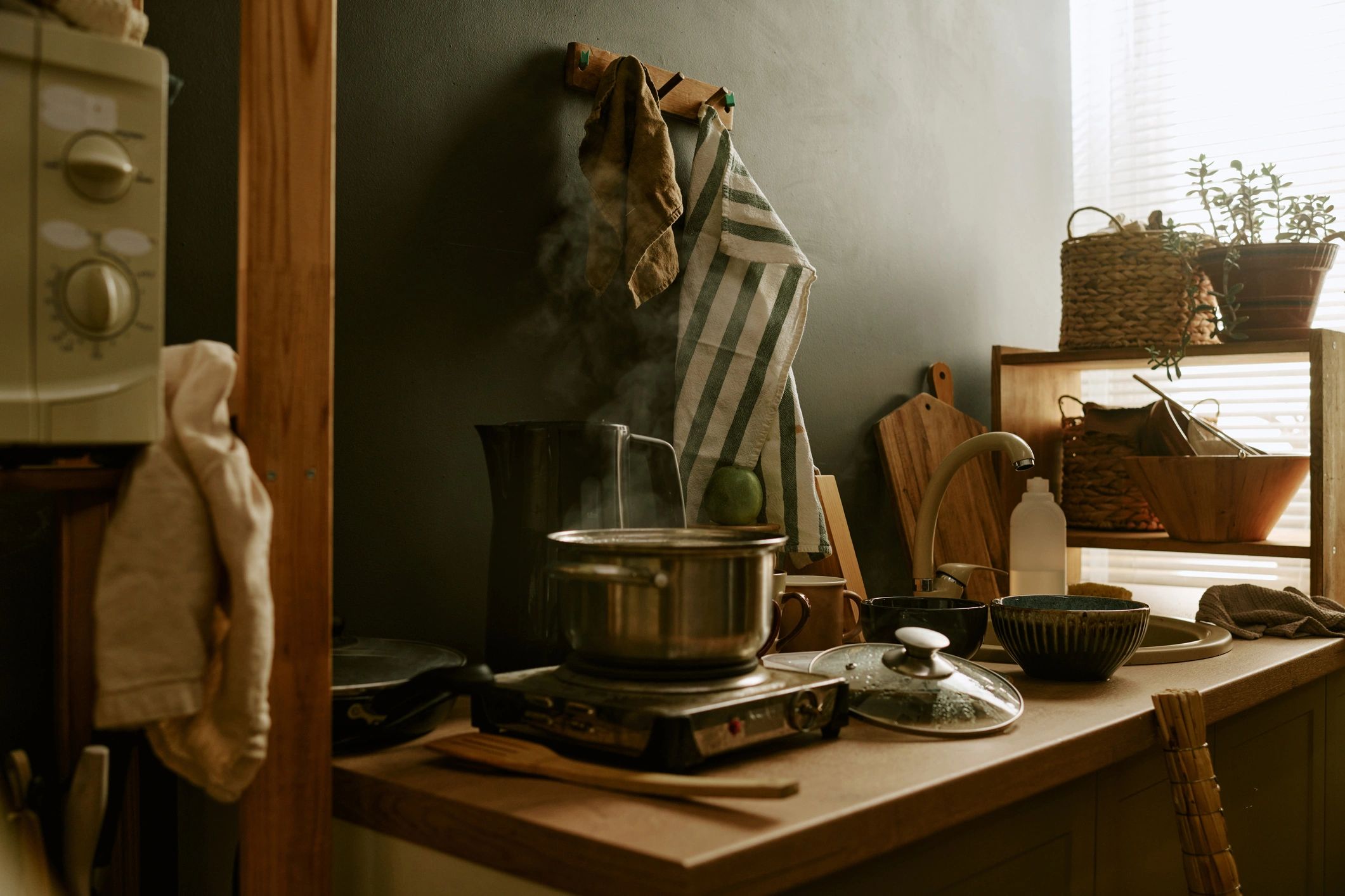 Kitchen cookware and utensils arranged in a home kitchen
